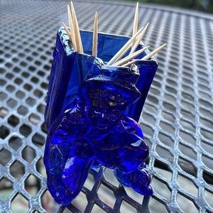 Cobalt glass toothpick or match holder with a boy kneeling
